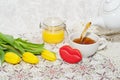 Side view of the pouring of tea, flowers, cookies and honey. Selective focus Royalty Free Stock Photo