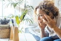 Side view of pretty adult woman touching her face and temples checking for wrinkles in front of a mirror. Concept of middle age Royalty Free Stock Photo