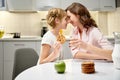 Mother and daughter eating cookies and drinking milk Royalty Free Stock Photo