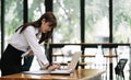 Side view pretty young business woman working with her computer in the office. asian woman using laptop Royalty Free Stock Photo