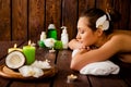 Side view of pretty young woman laying in spa salon with closed eyes and relaxed Royalty Free Stock Photo