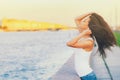 Side view profile portrait of a happy brunette woman relaxing breathing fresh air outdoors in summer Girl with long hair doing Royalty Free Stock Photo