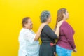 Side view profiles of three generations of Mexican women smiling with casual clothes in a row Royalty Free Stock Photo