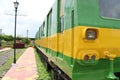 Side view of random green yellow coloured Indian Metro Railway metal coach