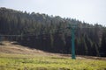 Side view of red chairlift ride to mountains with beautiful nature background.