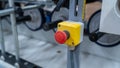 Emergency stop button on industrial machine with rollers and metal frame Royalty Free Stock Photo