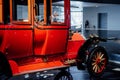 Side view of the red retro vintage car standing on the blue floor indoor Royalty Free Stock Photo