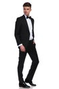 Side view of relaxed businessman in tuxedo looking behind