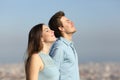 Relaxed couple breathing fresh air with urban background