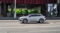 Side view rolling shot with Audi Q3 Sportback car in motion. Second generation crossover driving along the street in city with Royalty Free Stock Photo
