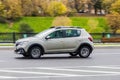 Side view rolling shot with Dacia Sandero Stepway subcompact car. Fast moving beige small hatchback with motion blur effect Royalty Free Stock Photo