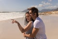 Side view of romantic happy young couple embracing on beach Royalty Free Stock Photo