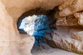 Side view on the round entrance tunnel to unique sea cave in massive rock in Tropea city near the famous Rotonda beach. Tyrrhenian Royalty Free Stock Photo