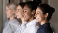 Side view row of diverse female staff of company