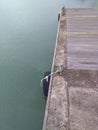 Side View of a rubber wheel attached to a metallic bollard on a dock.-Ship protection. Royalty Free Stock Photo