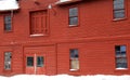 Side view of rustic red barn on snowy day Royalty Free Stock Photo