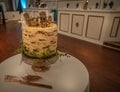 Side view of a rustic style wedding cake themed around camping