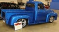 Side view of a 1940's model Blue Ford pick-up truck.