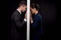 Side view of sad couple in formal wear separated by wall Royalty Free Stock Photo