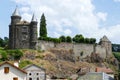 The Sailhant castle on top of a rocky outcrop overlooking the houses of the hamlet Royalty Free Stock Photo