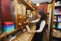 Side view of salesperson dispensing coffee beans into paper bag at store