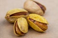 side view of salted roasted pistachios on old paper texture background Royalty Free Stock Photo