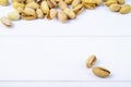 side view of salted roasted pistachios on white background with copy space Royalty Free Stock Photo