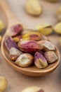 side view of salted roasted pistachios on a wooden spoon Royalty Free Stock Photo