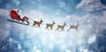 Composite image of side view of santa claus riding on sleigh during christmas Royalty Free Stock Photo