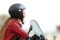 Satisfied biker looking away on a motorbike