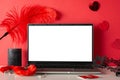 Side view scene with a laptop, candle, mask, and adult toysÃ¢â¬âfurry handcuffs and feather tickler on a red background