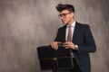 Side view of a seated young business man holding briefcase Royalty Free Stock Photo