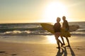 Old couple with surfboard at the beach