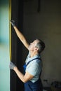 Senior Worker Measuring Window