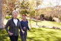 Side View Of Senior Couple Power Walking Through Park Royalty Free Stock Photo