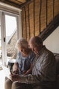 Senior couple using laptop in living room Royalty Free Stock Photo