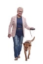 side view . senior lady and her dog walking together