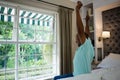 Side view senior man stretching arms while sitting on bed