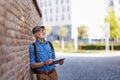 Senior tourist exploring new city, interesting places. Elderly man holding tablet and looking for the route. Traveling Royalty Free Stock Photo