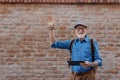Senior tourist exploring new city, interesting places. Elderly man holding tablet and looking for the route. Traveling Royalty Free Stock Photo