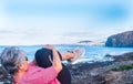 Side view of senior woman doing fitness exercises at the beach. Sport clothing. Horizon over the water Royalty Free Stock Photo