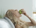 Side view of sensuous woman biting apple in house Royalty Free Stock Photo