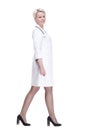serious woman doctor stepping forward . isolated on a white background. Royalty Free Stock Photo
