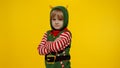 Shocked kid girl in Christmas elf Santa helper costume. Child look at camera and ask question what
