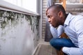 Shocked Man Looking At Mold On Wall Royalty Free Stock Photo