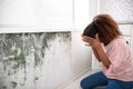 Shocked Woman Looking At Mold On Wall Royalty Free Stock Photo