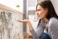 Shocked Woman Looking At Mold On Wall Royalty Free Stock Photo