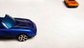 Side view shot of bonnet of blue toy car on clean background with orange car Royalty Free Stock Photo