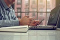 Side view shot of a man`s hands using smart phone in interior, rear view of business man hands busy using cell phone at office des Royalty Free Stock Photo