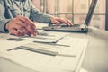 Side view shot of a man`s hands using smart phone in interior, rear view of business man hands busy using cell phone at office des Royalty Free Stock Photo